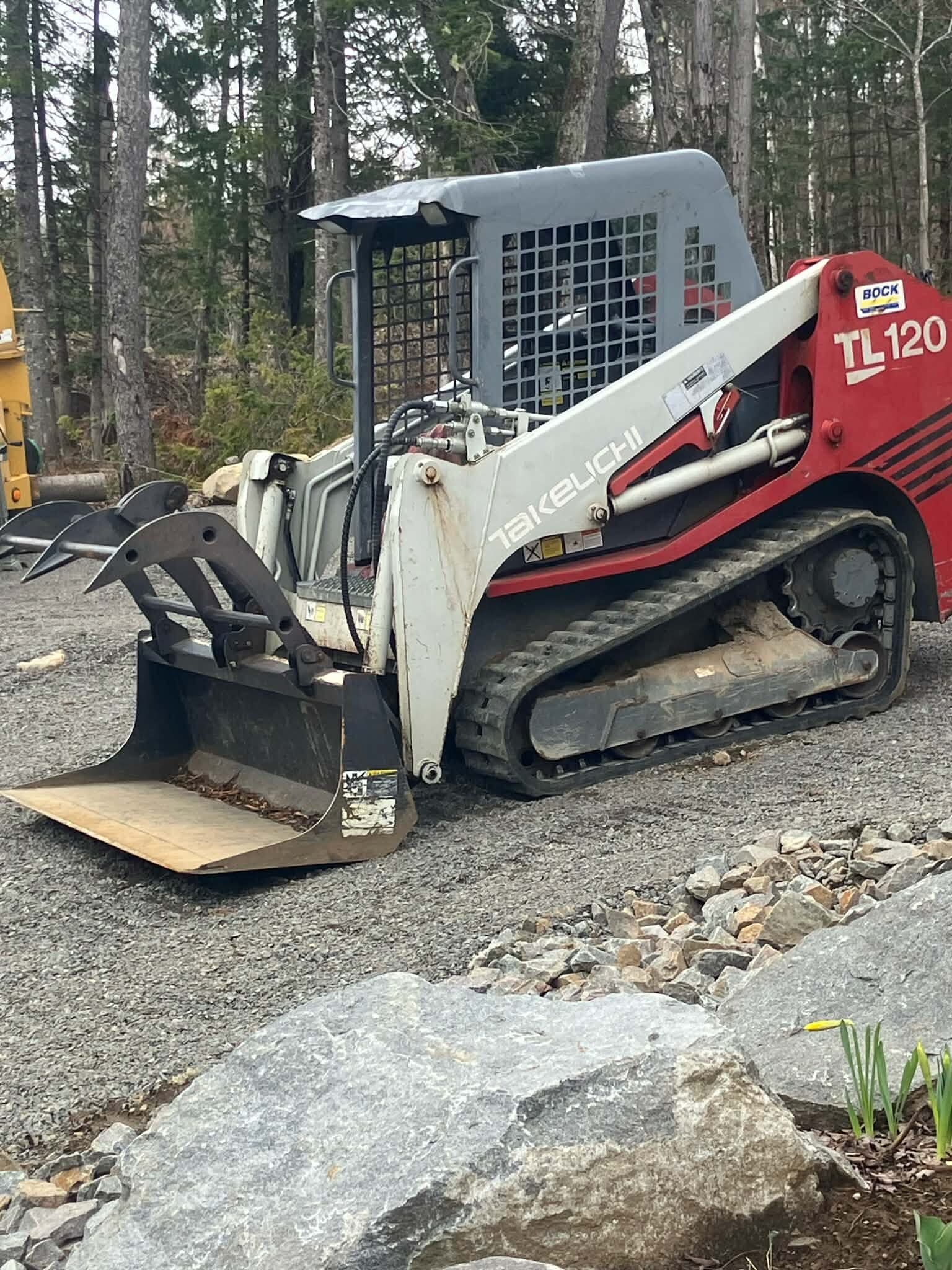 Tracked Bobcat Takeuchi TL120 on a residential property
