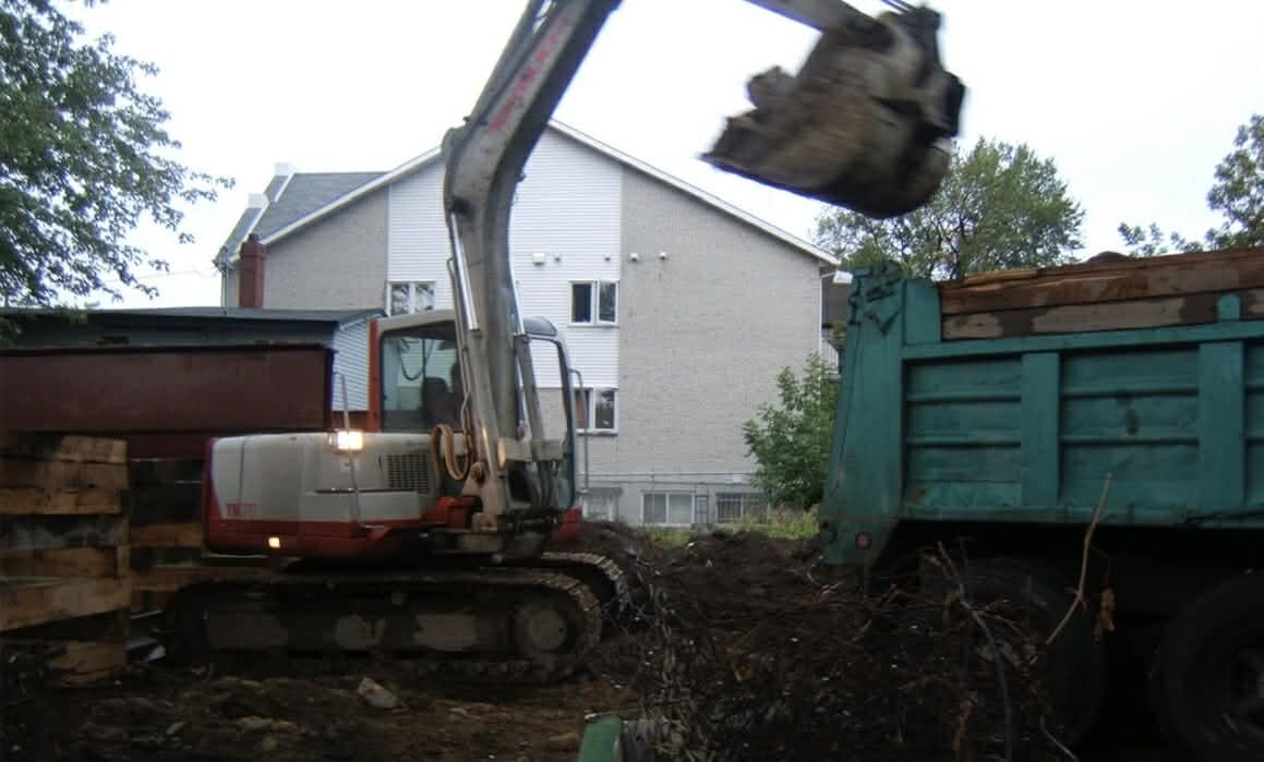 Takeuchi excavator at work grading a site